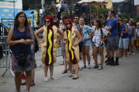 <p>Women dressed as hotdogs wait in line to attend the Annual Nathan’s Hot Dog Eating Contest on July 4, 2018 in the Coney Island neighborhood of the Brooklyn borough of New York City. In 2017 winner Joey Chestnut set a Coney Island record eating 72 hot dogs. (Photo: Eduardo Munoz Alvarez/Getty Images) </p>