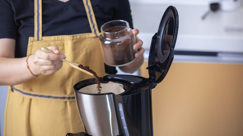 Woman making coffee in pot