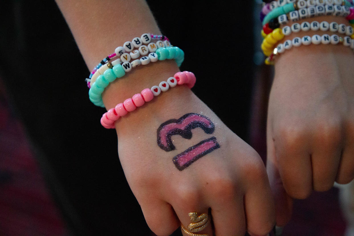 Shayla Stoinski shows off her friendship bracelets and painted hand.