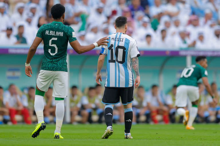 Saudi Arabia's defender #05 Ali Al-Bulaihi pats on the shoulder of Argentina's forward #10 Lionel Messi during the Qatar 2022 World Cup Group C football match between Argentina and Saudi Arabia at the Lusail Stadium in Lusail, north of Doha on November 22, 2022. (Photo by Odd ANDERSEN / AFP)