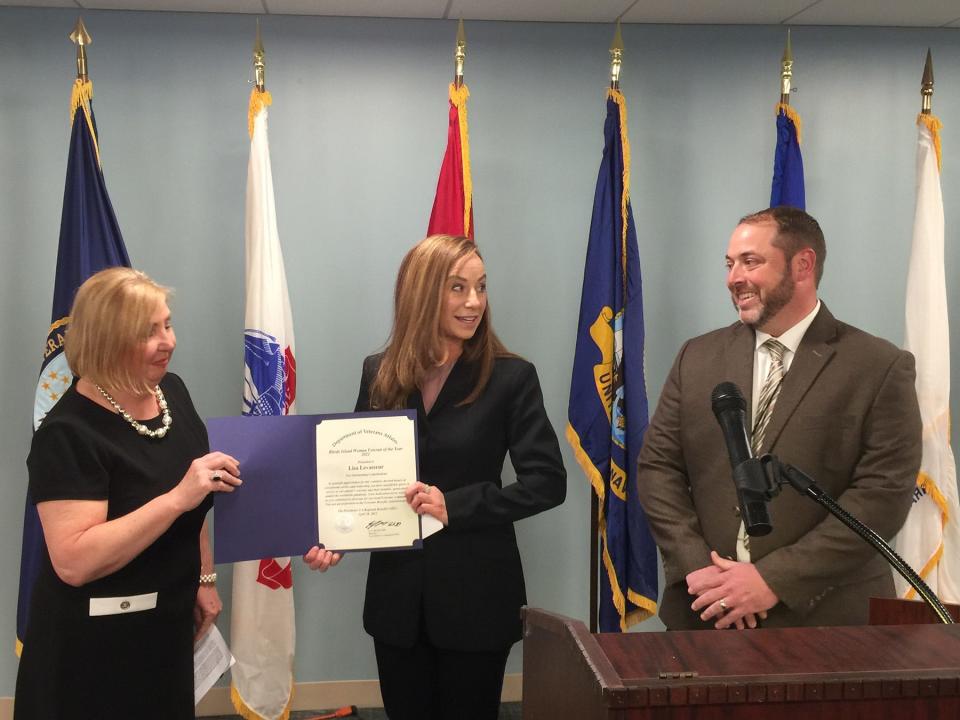 Lisa Levasseur receives the VA Regional Office's 5th Annual Rhode Island Woman Veteran of the Year Award on Thursday. Making the presentation is 2019 recipient Michele Diamond, left, and Tim McGorty from the VA.