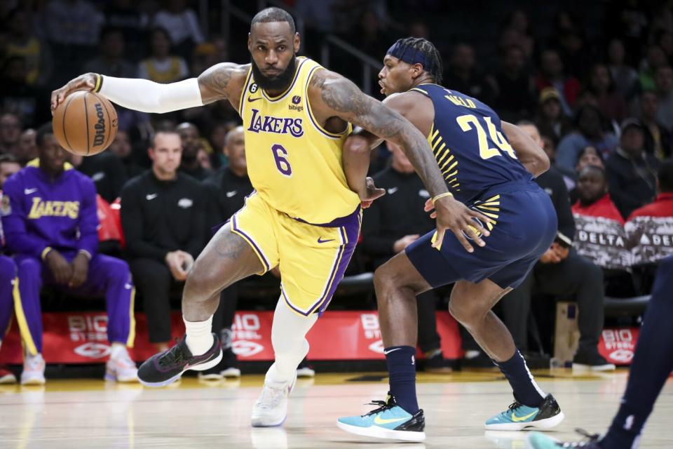 Lakers forward LeBron James drives to the basket while Indiana Pacers guard Buddy Hield defends.