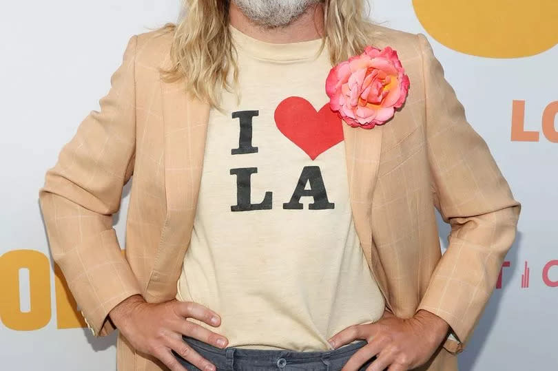 Chris Pine looked unrecognisable as he stepped out with long blonde hair and a bushy beard for the premiere of his new movie, Poolman