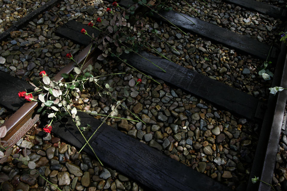 In this Monday May 9, 2015, file photo, roses are put on the railroad tracks at former concentration camp Westerbork, the Netherlands, Monday May 9, 2005, to remember more than a hundred thousand Jews who were transported from Westerbork to Nazi death camps. The Dutch national railway company NS says it will set up a commission to investigate how it can pay individual reparations for its role in mass deportations of Jews by Nazi occupiers during World War II. (AP Photo/Peter Dejong)