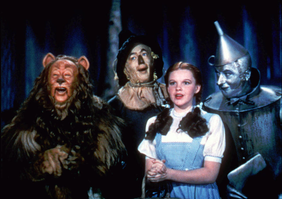 FILE - In this undated file photo provided by Warner Bros., Bert Lahr as the Cowardly Lion, Ray Bolger as the Scarecrow, Judy Garland as Dorothy, and Jack Haley as the Tin Woodman, sing in this scene from "The Wizard of Oz," distributed by Warner Bros. On Sunday, Nov. 11, 2012, auction house Julien's Auctions said the blue pinafore dress that Garland wore in the movie fetched the highest price of any item during a two-day auction of Hollywood memorabilia that attracted bids from around the world, selling for $480,000. (AP Photo/Warner Bros., File) NO SALES