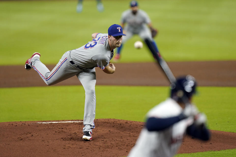 Texas Rangers starting pitcher Kyle Cody, left, throws to Houston Astros' George Springer during the first inning of a baseball game Tuesday, Sept. 15, 2020, in Houston. (AP Photo/David J. Phillip)