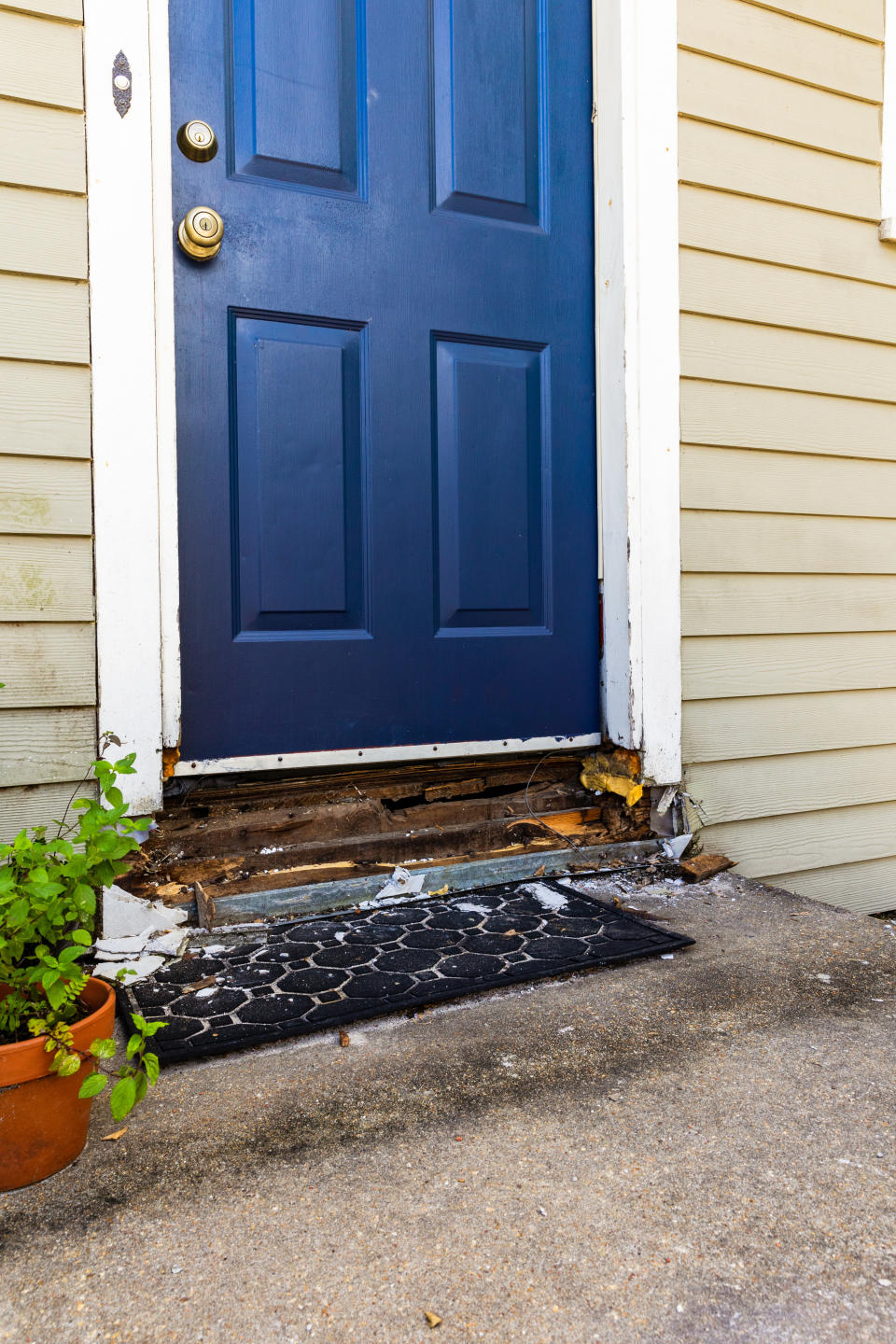 wood rotted underneath the frame of an exterior door