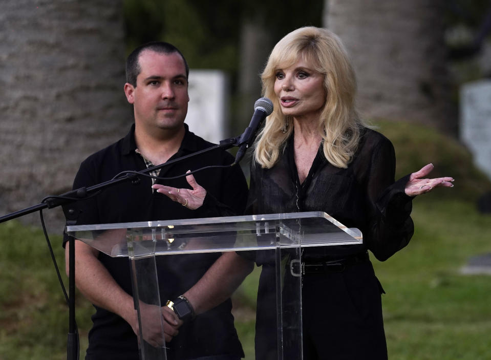 Actress Loni Anderson and her son Quinton Reynolds speak before the unveiling of a memorial sculpture of her former husband and Quinton's father, the late actor Burt Reynolds, at Hollywood Forever Cemetery, Monday, Sept. 20, 2021, in Los Angeles. Reynolds died in 2018 at the age of 82. (AP Photo/Chris Pizzello)