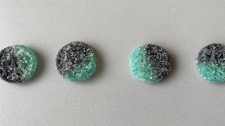 four black and green candies