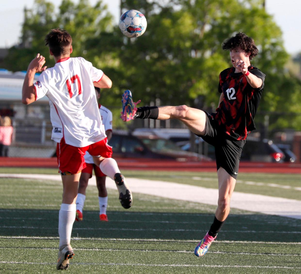 Crossings Christian's Kaden Laisle kicks the ball next to Purcell's Tyler Clark during a boys soccer game against Crossings Christian in Oklahoma City, Tuesday, April 16, 2024.