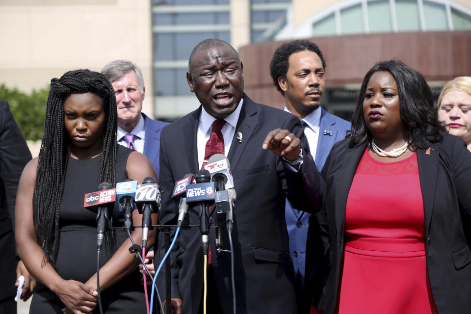 Attorney Benjamin Crump, center, flanked by Britany Jacobs, left, and Clearwater attorney Michele Rayner, right, speaks to the media at the Pinellas County Criminal Justice Center Thursday, July 26, 2018, in Clearwater, Fla. Crump, an attorney for the family of Markeis McGlockton, an unarmed black man fatally shot by a white man in a Florida parking lot said Thursday that race is the reason no charges have been filed after the videotaped altercation. (Douglas R. Clifford/Tampa Bay Times via AP)