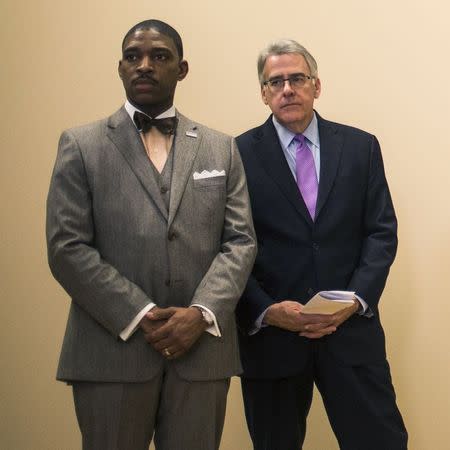 Reverend Starsky Wilson (L) and Richard McClure, co-Chairs of the Ferguson Commission, stand near Missouri Governor Jay Nixon (not seen) during a news conference in St. Louis, Missouri November 18, 2014. REUTERS/Adrees Latif