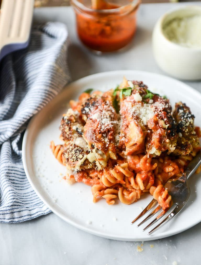 cheesy chicken parmesan pasta bake on plate with fork