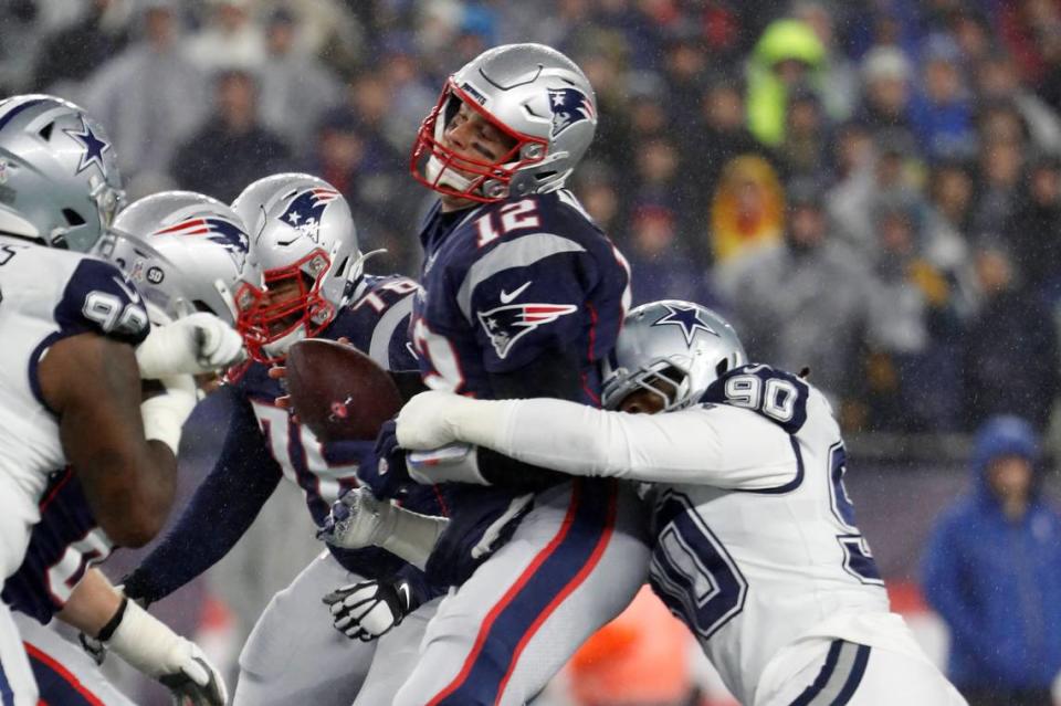 New England Patriots quarterback Tom Brady is sacked by Dallas Cowboys defensive end Demarcus Lawrence during an NFL football game at Gillette Stadium, Sunday, Nov. 24, 2019 in Foxborough, Mass.