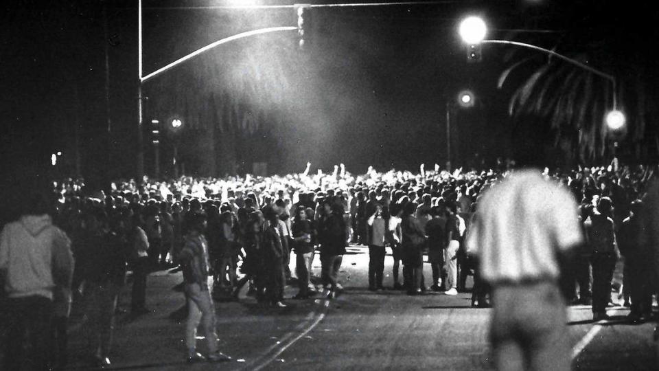 A CHP helicopter lights up the crowd Saturday night April 28, 1990 at California and Foothill boulevards before riot-equipped officers moved in.