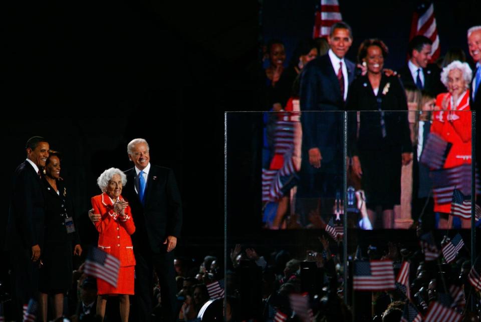 Then-President elect Barack Obama stands on stage with Vice-President elect Joe Biden and his mother Jean in Chicago in November 2008 (Getty Images)