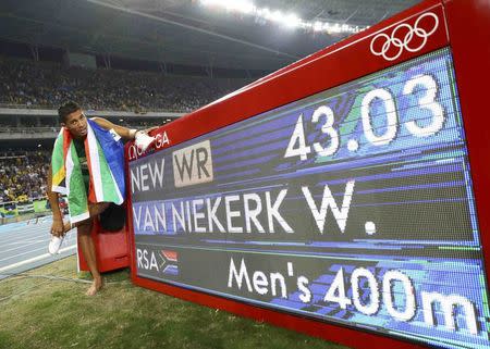 2016 Rio Olympics - Athletics - Final - Men's 400m Final - Olympic Stadium - Rio de Janeiro, Brazil - 14/08/2016. Wayde van Niekerk (RSA) of South Africa celebrates after winning the gold. REUTERS/Kai Pfaffenbach