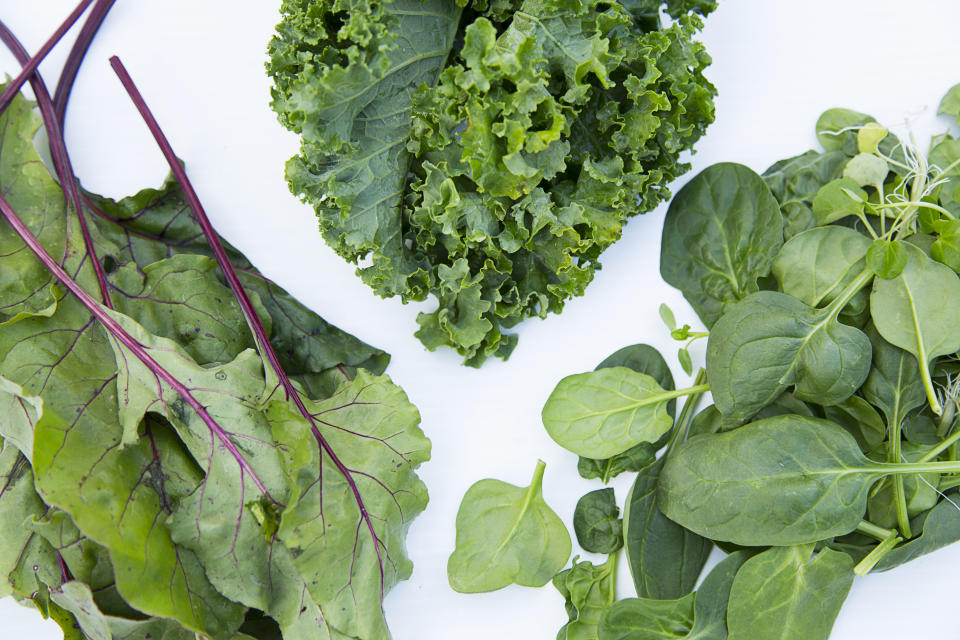 Assortment of leafy greens including kale, spinach, and rainbow chard