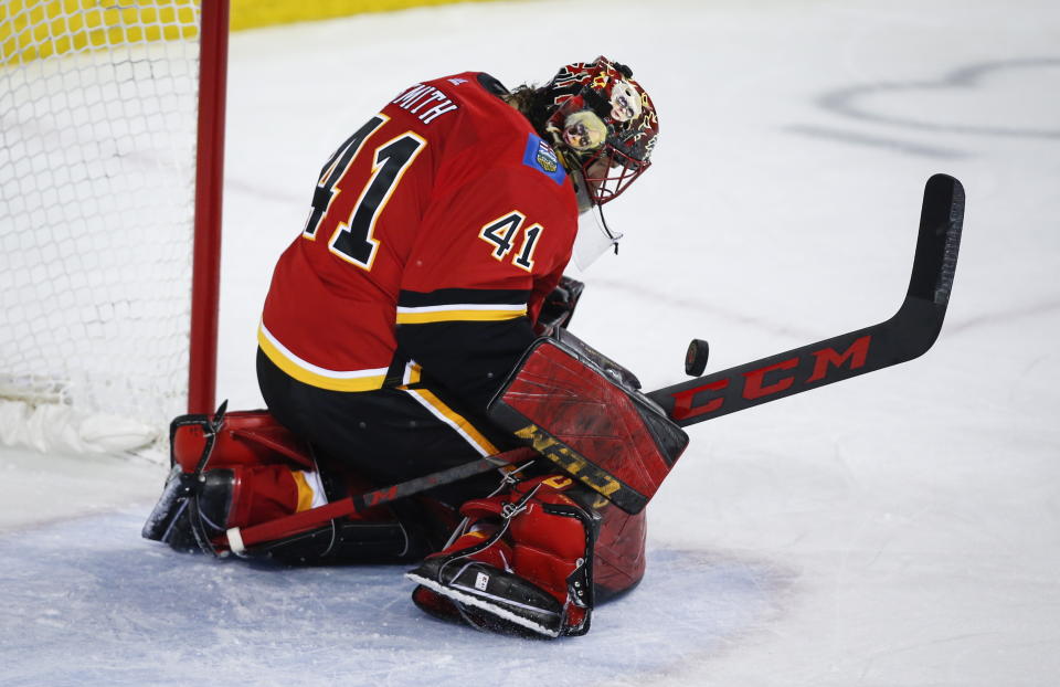 Calgary Flames goalie Mike Smith makes a save during second-period NHL hockey game action against the Los Angeles Kings in Calgary, Alberta, Monday, March 25, 2019. (Jeff McIntosh/The Canadian Press via AP)