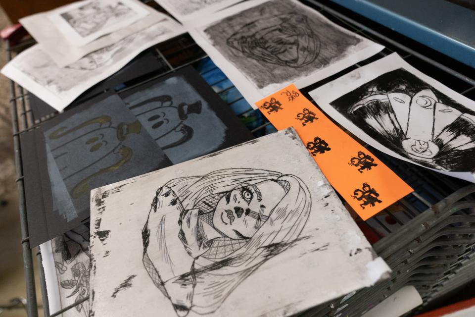 Topeka High students print work dries on a drying rack Tuesday morning in art teacher Amy Cline's classroom.