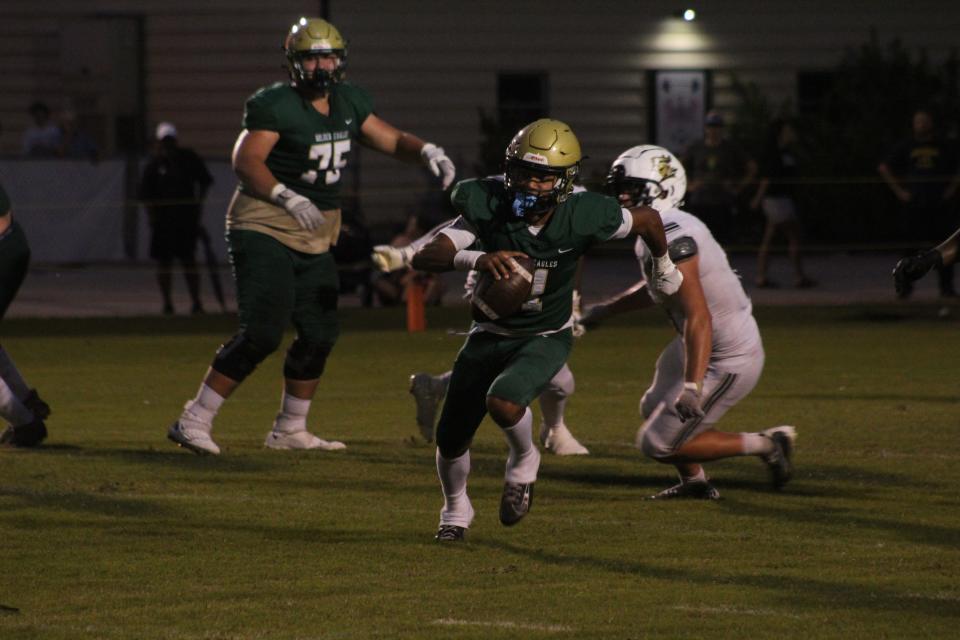 Fleming Island quarterback Cibastian Broughton scrambles against Oakleaf.