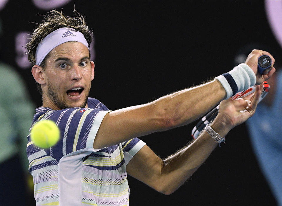 FILE - In this Wednesday, Jan. 29, 2020 file photo, Austria's Dominic Thiem makes a backhand return to Spain's Rafael Nadal during their quarterfinal match at the Australian Open tennis championship in Melbourne, Australia. No. 3 Dominic Thiem – He was the runner-up in Melbourne to Novak Djokovic in 2020 and won his first Grand Slam title at the U.S. Open later in the year. (AP Photo/Andy Brownbill, File)