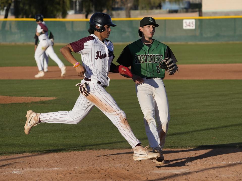 Hamilton's AJ Diaz (7) scores the winning run in front of San Luis pitcher Javier Rochin (5) during play at Hamilton High school baseball field. Hamilton won 16-6 in five innings in Chandler on March 28, 2023.