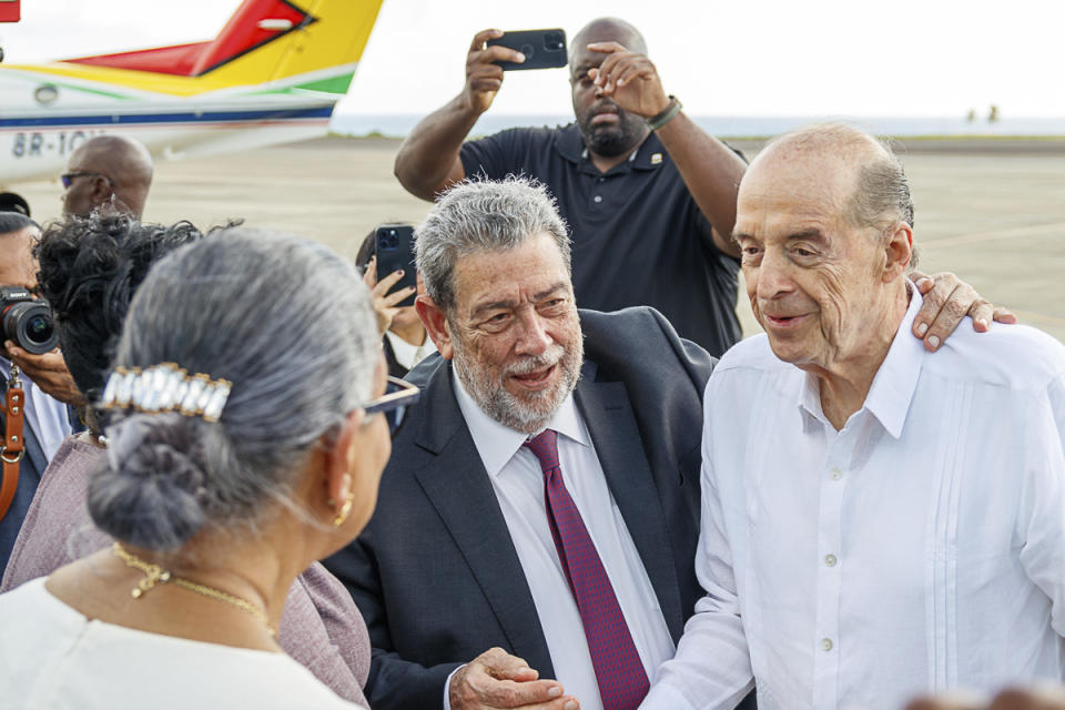 St. Vincent and the Grenadines Prime Minister Ralph Gonsalves, center, embraces Colombia's Foreign Minister Alvaro Leyva as leaders arrive to the Argyle International Airport in Argyle, St. Vincent, Thursday, Dec. 14, 2023. Leyva is in St. Vincent to attend a meeting between Venezuela and Guyana presidents over a long-standing dispute over the Essequibo territory, a vast border region rich in oil and minerals that represents much of Guyana's territory but that Venezuela claims as its own. (AP Photo/Lucanus D. Ollivierre)