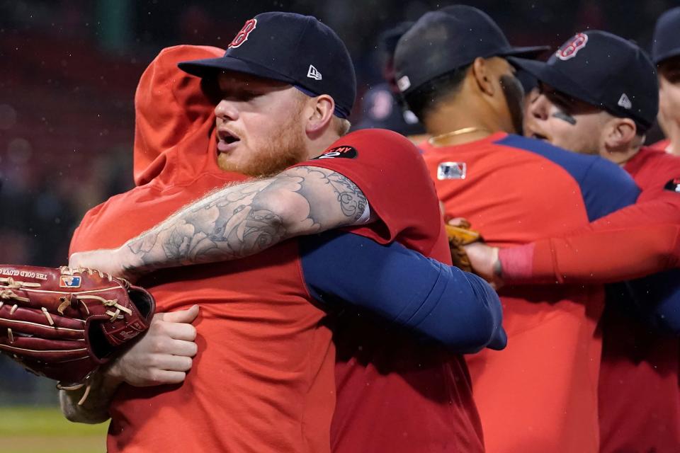 The Red Sox's Alex Verdugo, front right, and teammates embrace following the team's final regular-season game, against the Tampa Bay Rays on Wednesday.