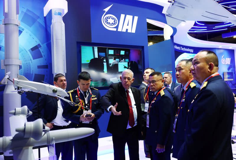 Thai Air Force leaders attend a presentation at the Israel Aerospace Industries booth during the Singapore Airshow