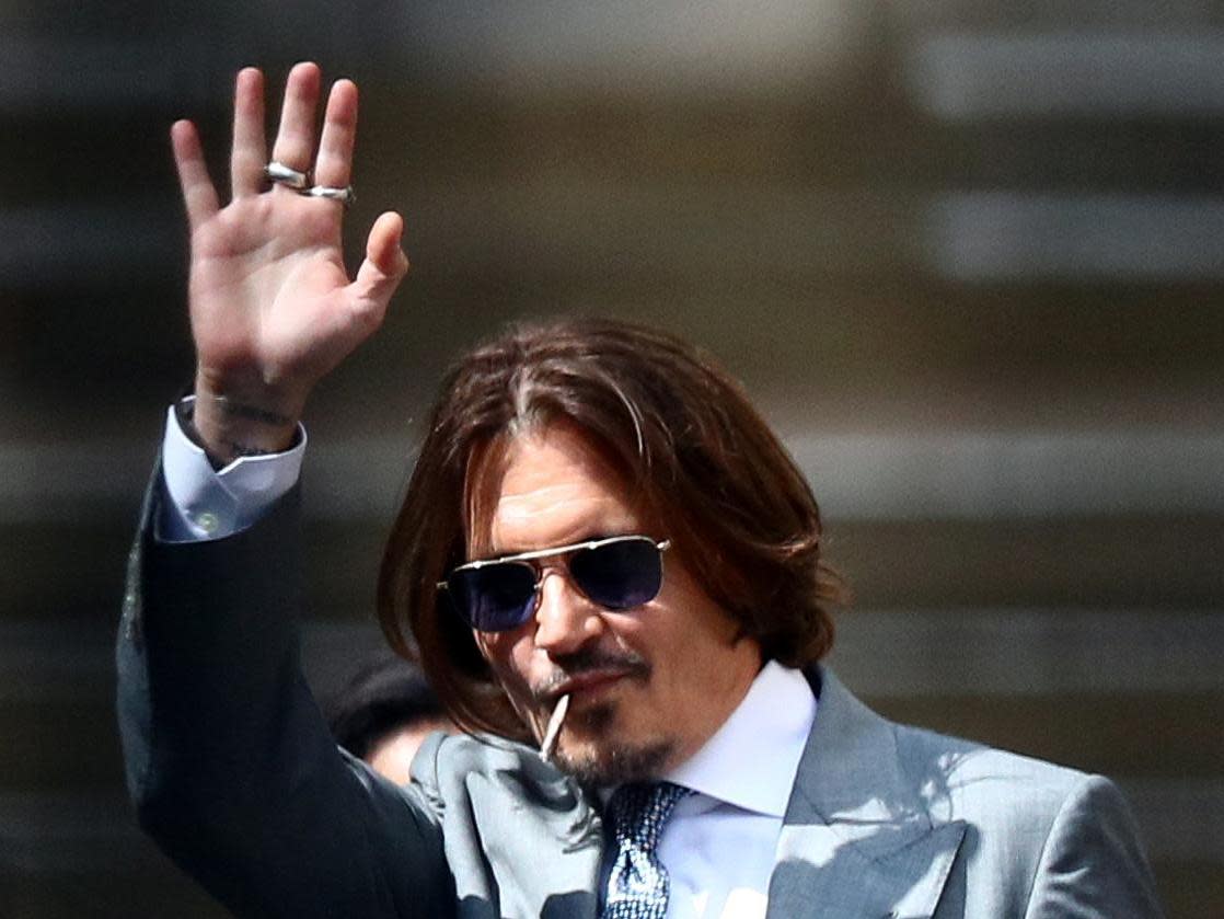 Johnny Depp waves as he leaves the High Court in London: REUTERS/Hannah McKay