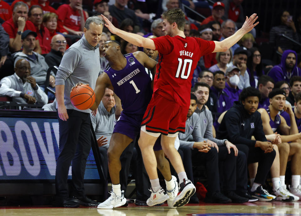 Northwestern guard Chase Audige (1) is fouled by Rutgers guard Cam Spencer (10) during the second half of an NCAA college basketball game, Sunday, Mar.5, 2023, in Piscataway, N.J. Northwestern won 65-53. (AP Photo/Noah K. Murray)