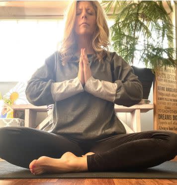 The author meditates on her yoga mat.