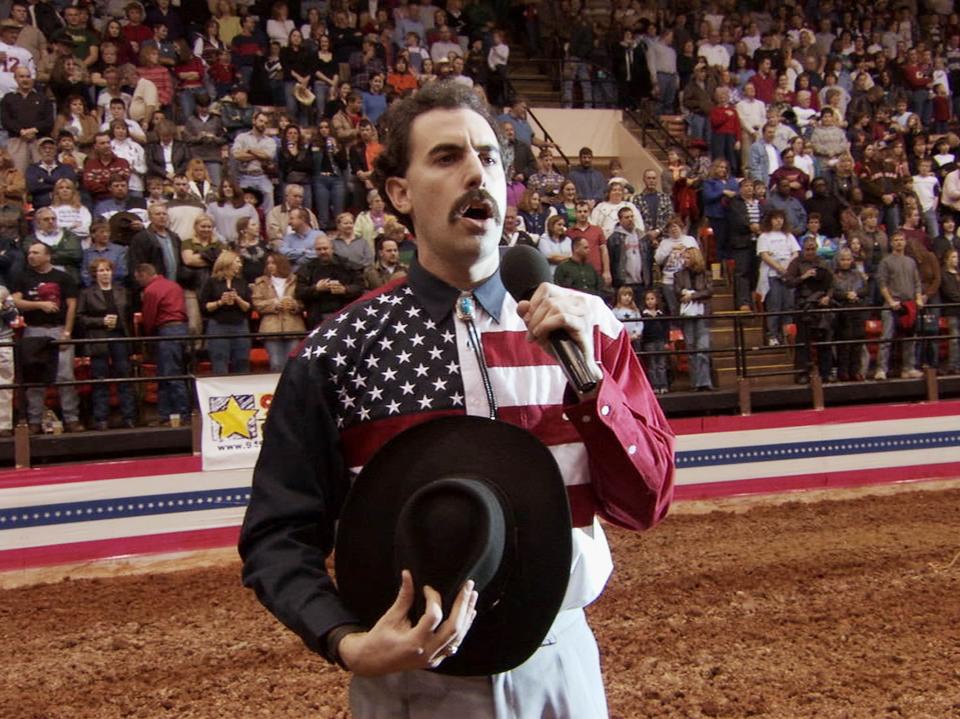 Very nice: Sacha Baron Cohen incites the fury of a crowd as he mangles the US anthem while singing at a rodeo (Fox)