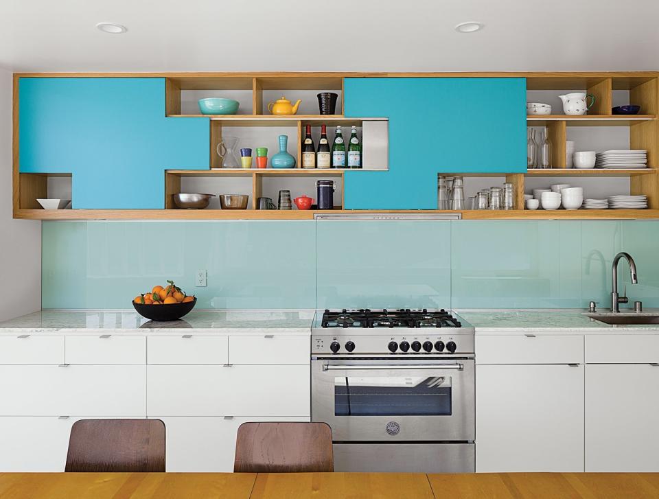 In this Palm Springs duplex, for cabinet doors, the architect owner designed aqua blue plywood sliders that park at specific positions, fitting together like puzzle pieces. Contractor Franklin Pineda custom-built these cabinets using Baltic birch plywood from Anderson Plywood.