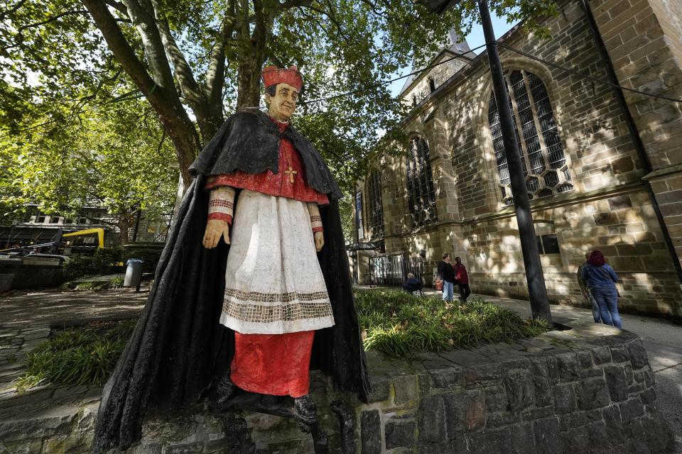 The monument of German cardinal Franz Hengsbach is seen beside the cathedral in the city center of Essen, western Germany, Friday, Sept. 22, 2023. The Catholic Church is investigating allegations of sexual abuse by the late cardinal over 30 years after his death. (AP Photo/Martin Meissner)