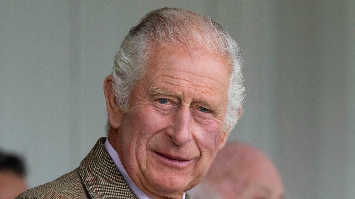 king charles smiling in tweed jacket at mey highland games