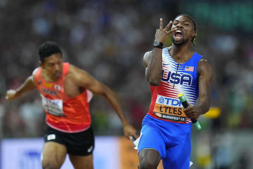 Noah Lyles, of the United States celebrates anchoring his team to gold in the Men's 4x100-meters relay final during the World Athletics Championships in Budapest, Hungary, Saturday, Aug. 26, 2023. (AP Photo/Petr David Josek)