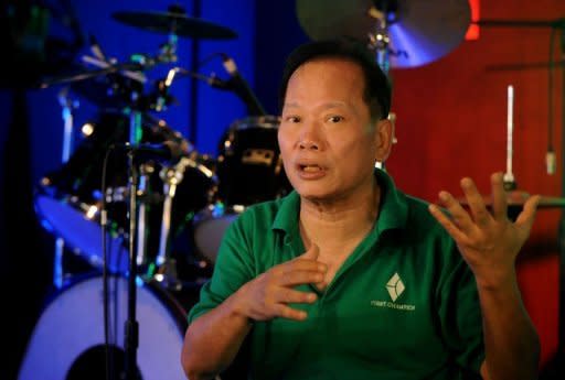 Jackson Gan, head of the music studio where singer Julia Talibong is recording a demo, gestures during an interview. Gan says Philippine musicians are well-known for their warm audience rapport, a reflection of a general easygoing nature for which Filipinos are famous