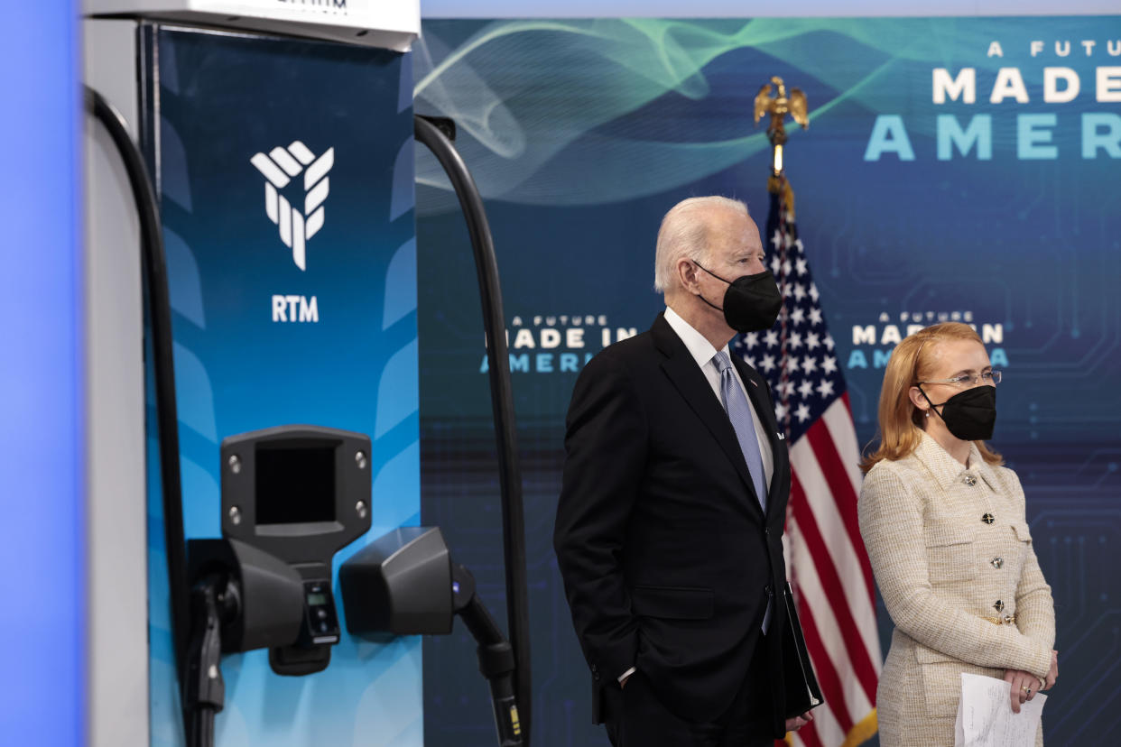 WASHINGTON, DC - FEBRUARY 08: U.S. President Joe Biden (L), joined by Tritium's CEO Jane Hunter, stands next to a Tritium electric vehicle charger during an event on the Biden administration's efforts to increase manufacturing, in the South Court Auditorium at the Eisenhower Executive Office Building on February 08, 2022 in Washington, DC. Biden announced plans for Tritium to construct a new electric vehicle charging plant in Tennessee. (Photo by Anna Moneymaker/Getty Images)