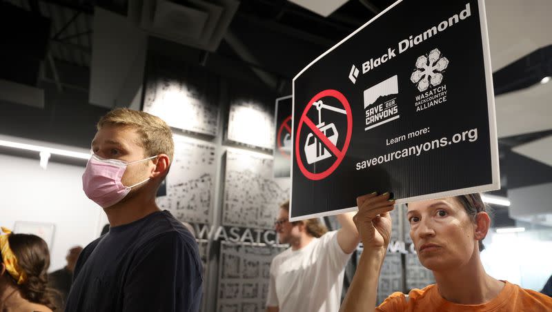 Patti Hobfoll holds up a sign protesting a Little Cottonwood Canyon gondola as people make public comments on the Regional Transit Plan (RTP), and whether or not to remove the gondola from the plan, during a Wasatch Front Regional Council meeting at the WFRC in Salt Lake City on Thursday, May 25, 2023. Despite the majority of public commenters who showed up to oppose the gondola at the meeting, the WFRC voted against removing the gondola from the Regional Transit Plan (RTP.)