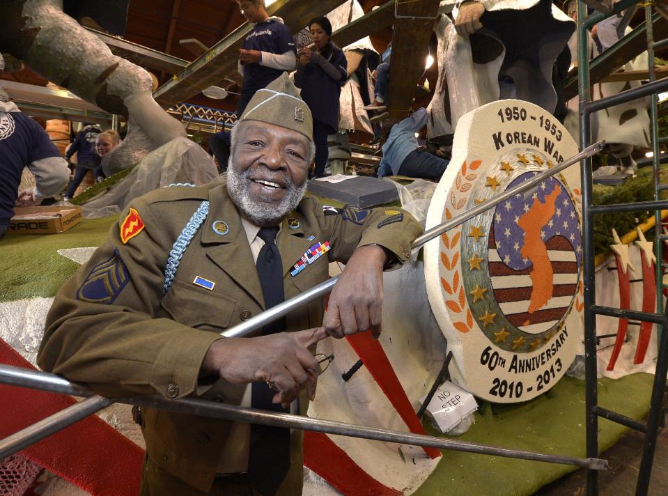 Korean War veteran James McEachin, 82, poses in front of the Rose Parade float “Freedom Is Not Free” by the Korean War Commemoration Committee, Saturday, Dec. 29, 2012, in Pasadena, Calif. McEachin is scheduled to ride the float in the Rose Parade on Tuesday, Jan. 1, 2013. (AP Photo/Mark J. Terrill)