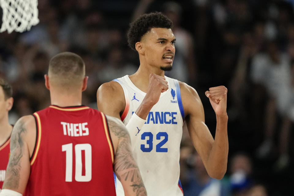 Victor Wembanyama (32) of France celebrates a basket against Germany during a men's basketball semifinal game at Bercy Arena at the 2024 Summer Olympics, Thursday, Aug. 8, 2024, in Paris, France. (AP Photo/Mark J. Terrill)