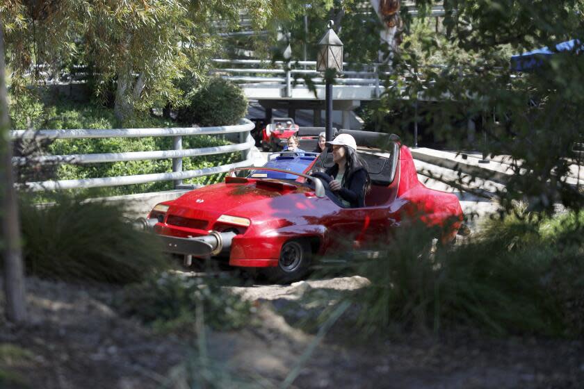 Anaheim, CA - March 11: Visitors ride the Disneyland Monorail passes by Tomorrowland in the background at Disneyland in Anaheim Monday, March 11, 2024. (Allen J. Schaben / Los Angeles Times)