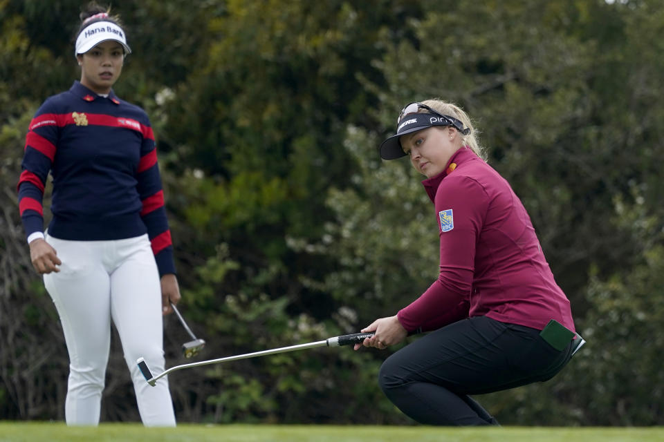 Brooke Henderson, of Canada, reacts as her putt drops in the cup on the first green as Patty Tavatanakit, of Thailand, left, looks on during the first round of the U.S. Women's Open golf tournament at The Olympic Club, Thursday, June 3, 2021, in San Francisco. (AP Photo/Jeff Chiu)