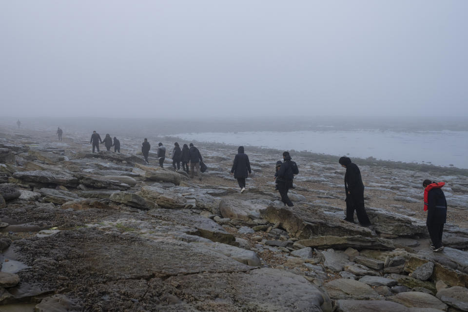 A group of Kurdish migrants from Iran and Iraq who failed in their attempt to reach the United Kingdom by boat walk back to the town of Ambleteuse, northern France, on Sunday, May 19, 2024, after being discovered by the police. (AP Photo/Bernat Armangue)