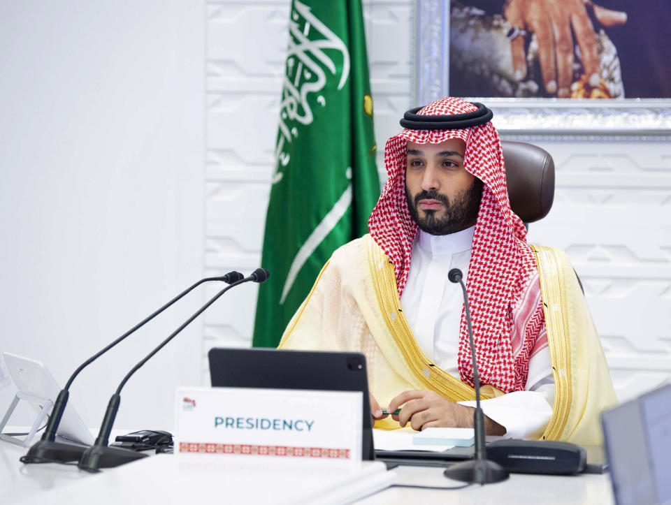 FILE - In this Sunday, Nov. 22, 2020, file photo, Saudi Arabia's Crown Prince Mohammed bin Salman attends a virtual G-20 summit held over video conferencing, in Riyadh, Saudi Arabia. One of the world's largest oil producers, Saudi Arabia, announced on Saturday, Oct. 23, 2021, it aims to reach “net zero” greenhouse gas emissions by 2060, joining more than 100 countries in a global effort to try and curb man-made climate change. (Bandar Aljaloud/Saudi Royal Palace via AP, File)