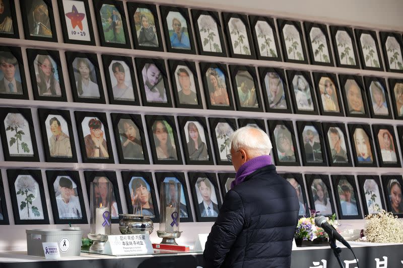 A man mourns at the memorial altar for victims before a press conference in Seoul