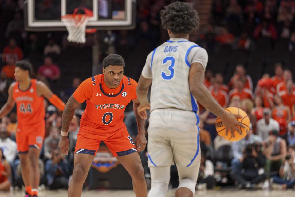 Auburn guard K.D. Johnson (0) defends against Memphis guard Kendric Davis (3) during the first half of an NCAA college basketball game on Saturday, Dec. 10, 2022, in Atlanta, Ga. (AP Photo/Erik Rank)