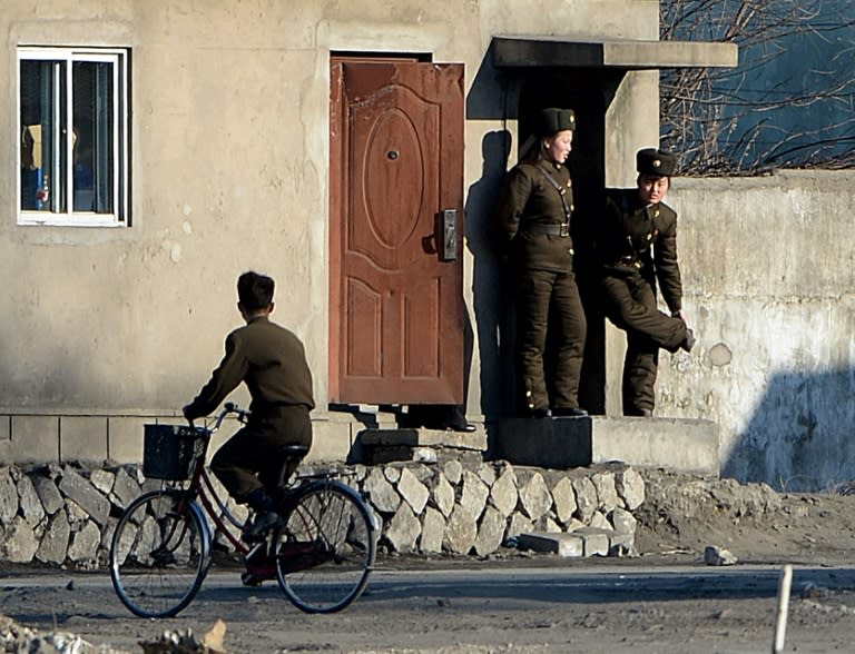 Female North Korean soldiers stand guard on the banks of the Yalu River which separates the North Korean town of Sinuiju from the Chinese border town of Dandong